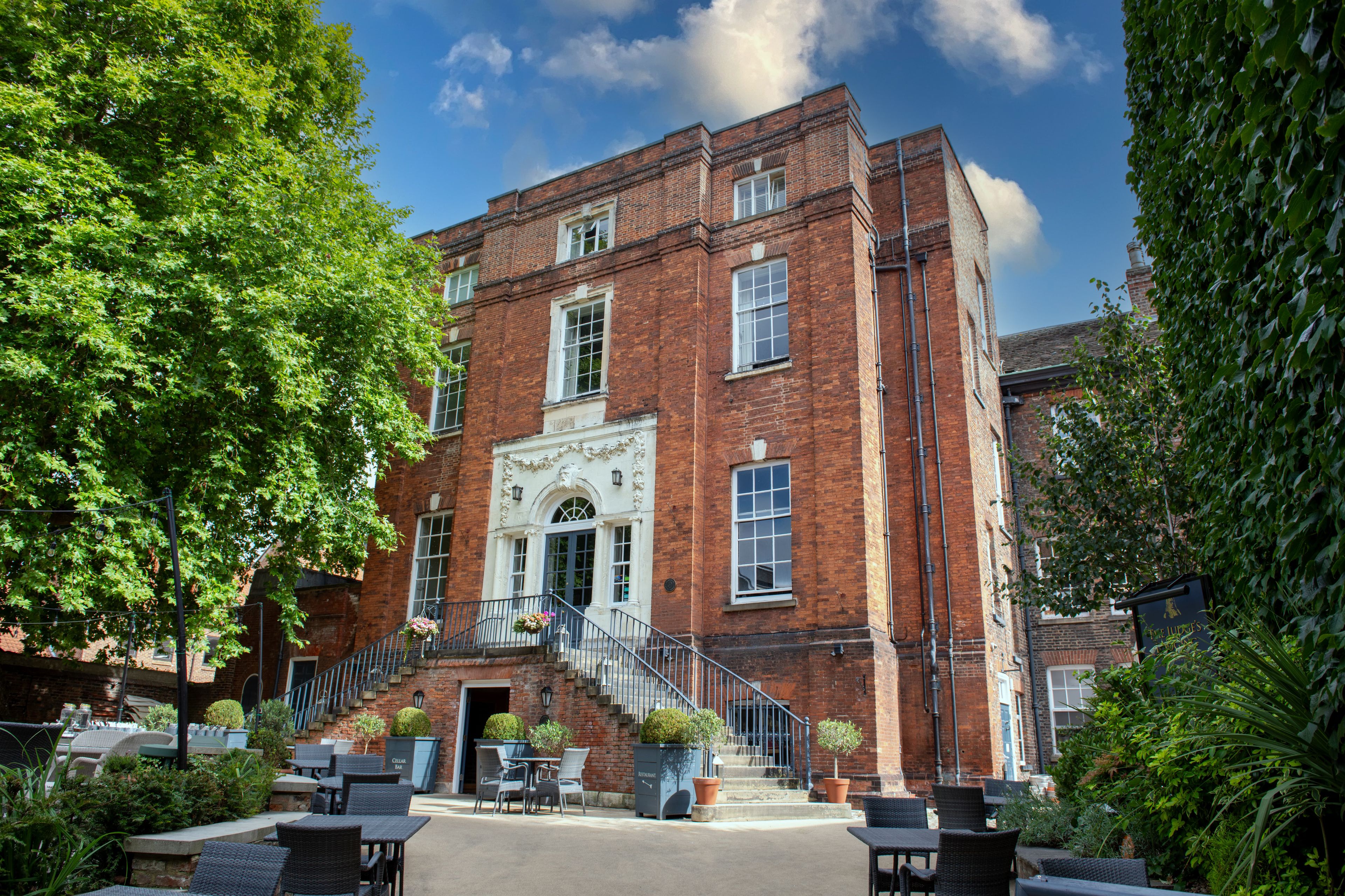 red brick mansion with outdoor seating