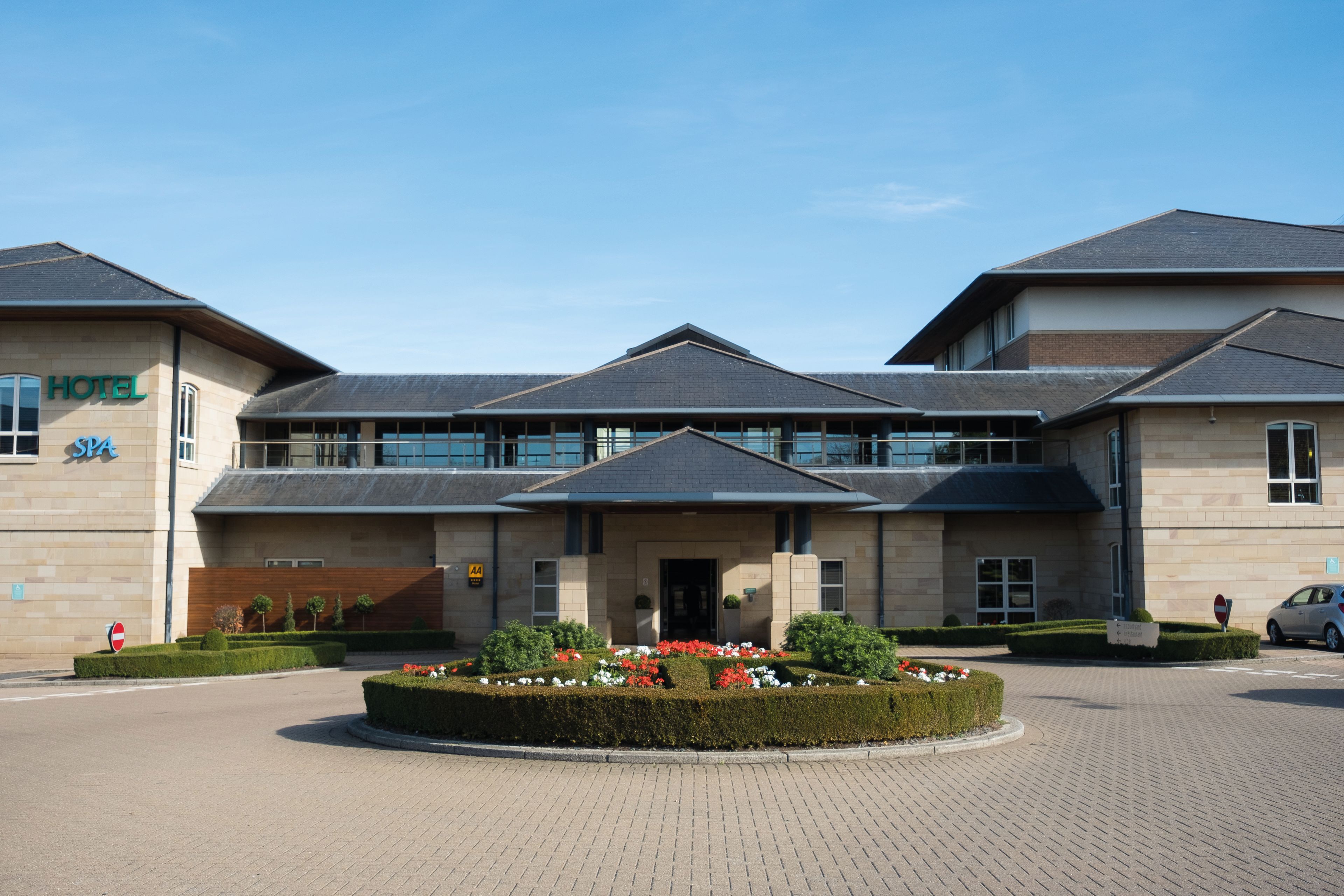 hotel building with circular driveway and flowers