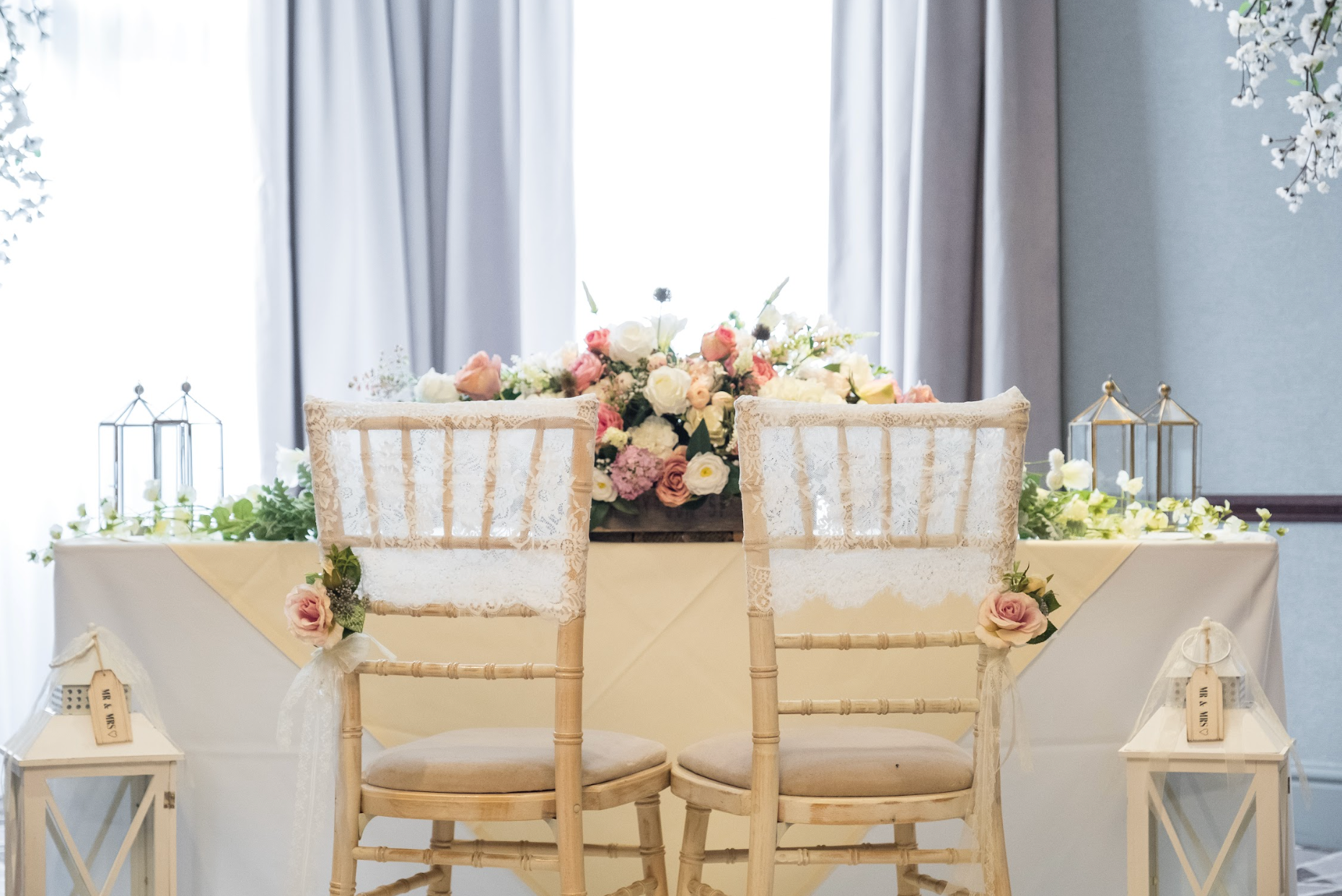 Two chairs in front of an adorned table with roses